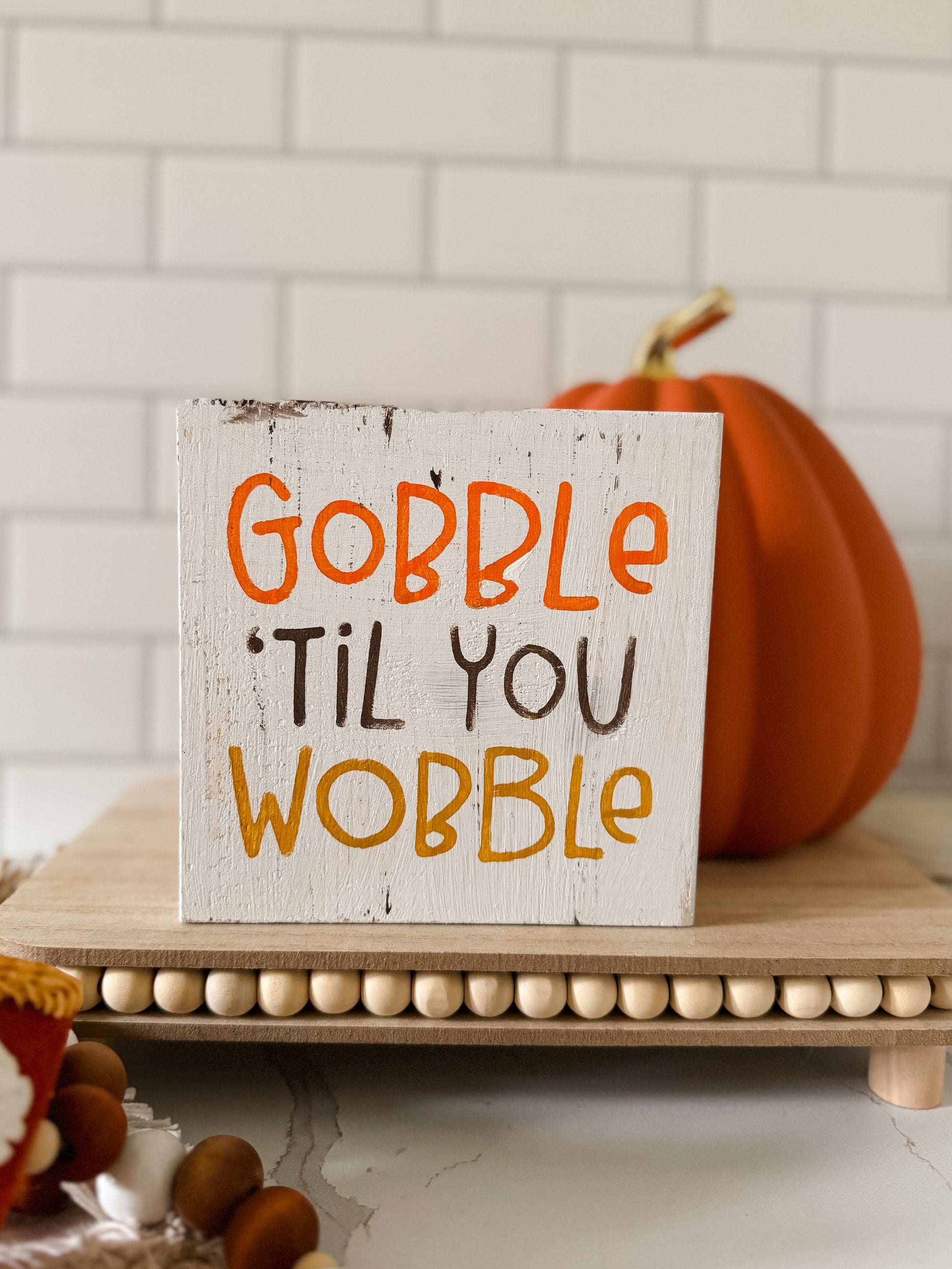 Get ready to gobble til you wobble with this quirky and funny wood sign! The perfect addition to your Thanksgiving decor, this sign will surely make your guests laugh and add a playful touch to your tiered tray set up. Don't miss out on this must-have Turkey Day sign!